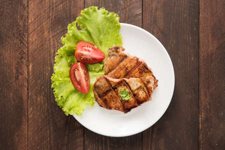 Grilled steak with vegetables on a dishの写真素材