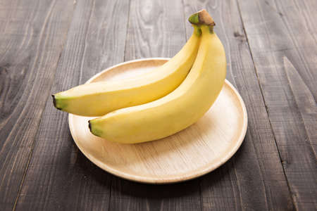Fresh bananas on wooden backgroundの写真素材