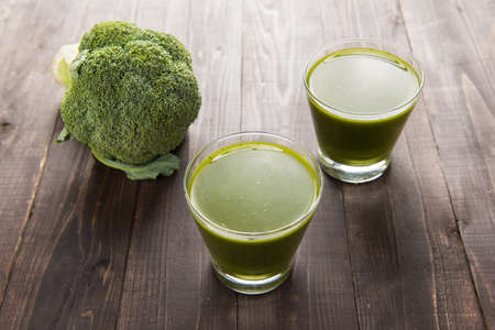 Top shot broccoli juice on wood tableの写真素材