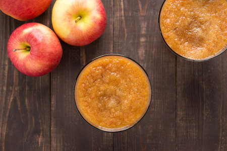 Top view red apples smoothie on wooden background.の写真素材