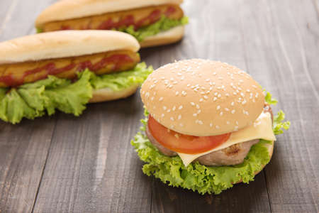 Hot dogs,hamburgers on the wooden backgroundの写真素材
