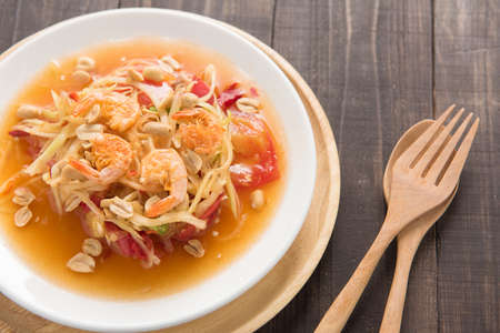 Papaya salad thai food on wooden background.の写真素材