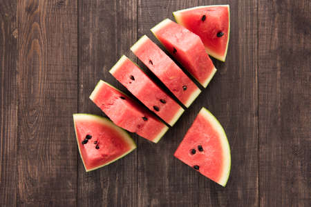 Slices of fresh watermelon on wooden background.の写真素材