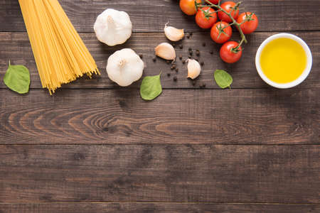 Pasta ingredients. tomato, garlic, pepper, oil and mushroom on wooden background.の写真素材