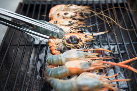 Grilled shrimps on the flaming grill, barbecue seafood.の写真素材