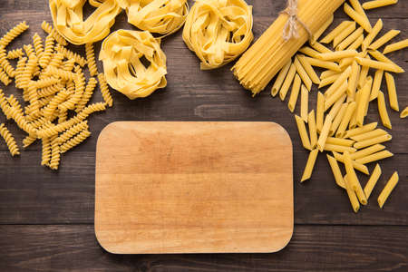 Pasta collection on rustic wooden background.の写真素材