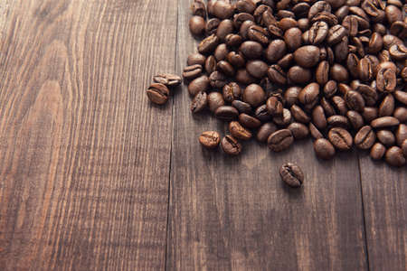Roasted coffee beans on the wooden background.の写真素材
