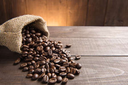 coffee beans in a bag on wooden background