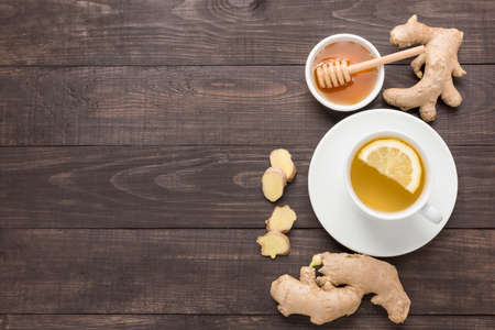 Cup of ginger tea with lemon and honey on wooden background.の写真素材