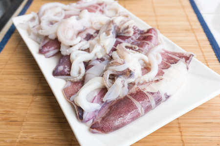 Fresh squid on a dish on the table.の写真素材