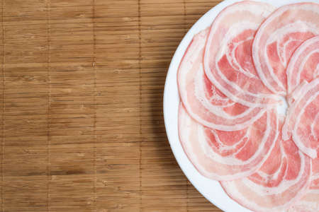 Slide raw pork on the table. Top view.の写真素材