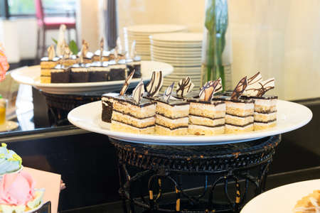 Various cake pieces of chocolate and vanilla on dish.の写真素材