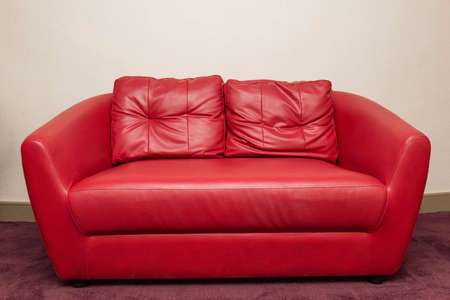 Red sofa in the room, white wall.の写真素材