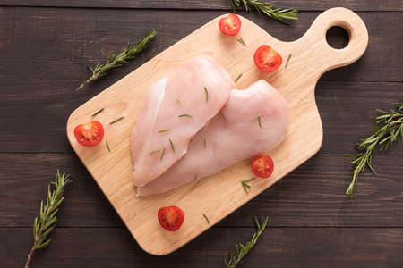 Raw chicken breast fillets on wooden background.の写真素材