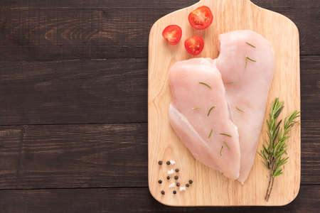 Top view raw chicken breast on wooden background.の写真素材