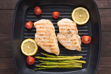 Marinated grilled chicken breasts cooked BBQ on a pan.の写真素材