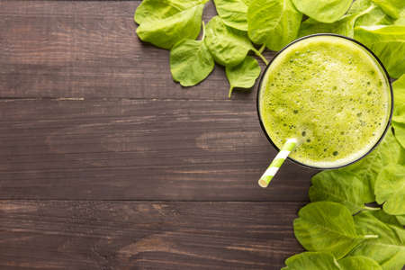 Healthy green smoothie on rustic wood background.の写真素材