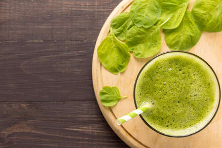 Healthy green smoothie on rustic wood background.の写真素材