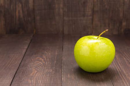 Green apple in the wooden background. Copy space.の写真素材