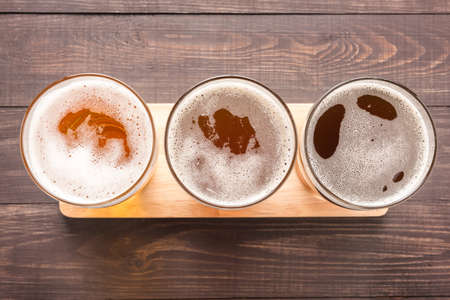 Assortment of beer glasses on a wooden background. Top view.の写真素材