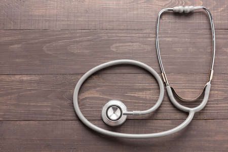 Stethoscope on wooden desk background. Top view.の写真素材