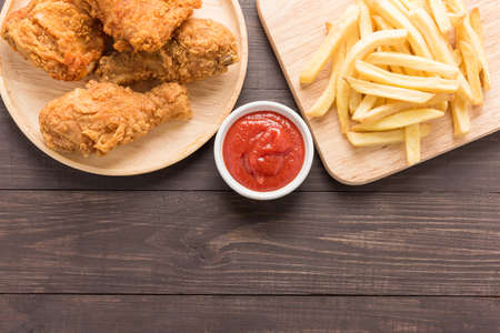 Fried chicken and french fries on a wooden background.の写真素材