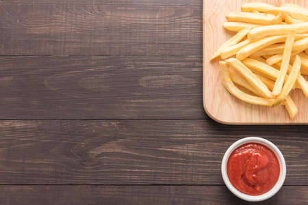 French fries with ketchup on wooden background.の写真素材