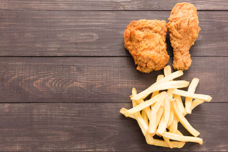 Fried chicken and french fries on a wooden background.の写真素材