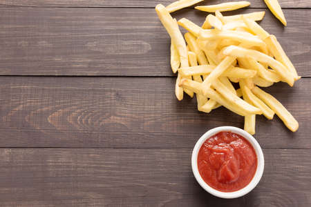 French fries with ketchup on wooden background.の写真素材