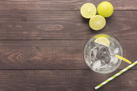 Fresh cocktail with soda, lime on a wooden background.の写真素材