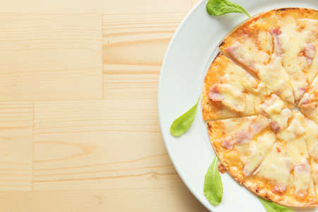 Rustic pizza on wooden background. Top viewの写真素材