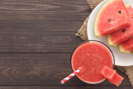 Healthy watermelon smoothie on a wood table.の写真素材