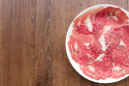 Slide raw meat on the table. Top view.の写真素材