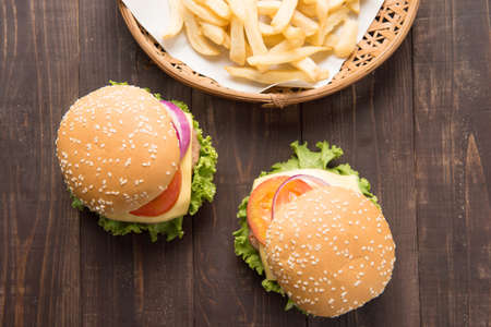 hamburger with french fries on wooden background.