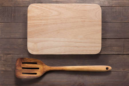 Cutting board and  spatula on the wooden background.の写真素材