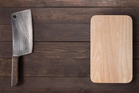 Cleaver and cutting board on the wooden background.の写真素材