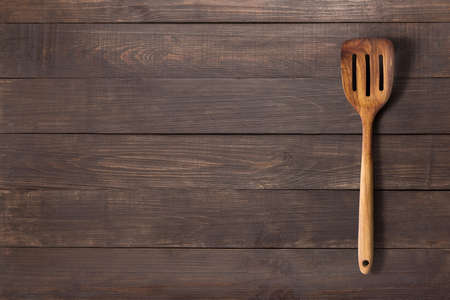 Spatula on the wooden background for you text.の写真素材