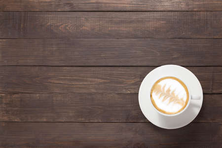 Coffee cup on wooden background. Top view.の写真素材