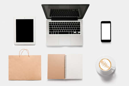 Design concept of mockup tablet, notebook, cell phone, book, coffee set isolated on white background.の写真素材