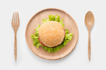 Eating bbq burger on wooden dish isolated on white background. Clipping Path included isolated on white background.の写真素材