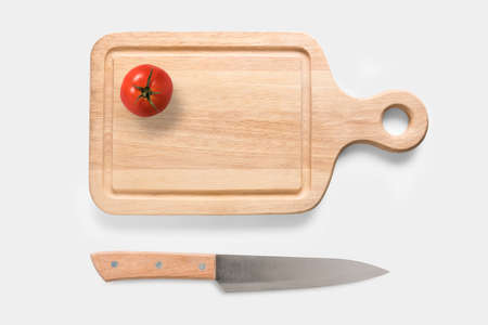 Design concept of mockup tomato on cutting board and knife set isolated on white background. Copyspace for text and logo. Clipping Path included on white background.の写真素材