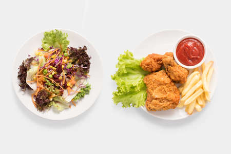 Concept of mock up fresh salad and Fried chicken and french fries set isolated on white background.の写真素材