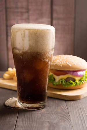 BBQ hamburgers with cola on wooden background.の写真素材