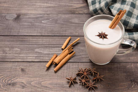 Masala chai with spices cinnamon, cardamom, ginger, clove and star anise on wooden background.の写真素材