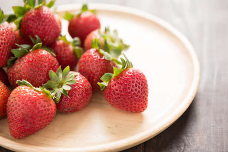 Fresh red strawberries on old wooden background.の写真素材