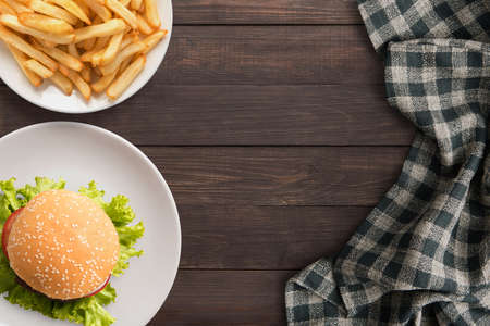 Fresh homemade burger and french fries on wooden table.の写真素材