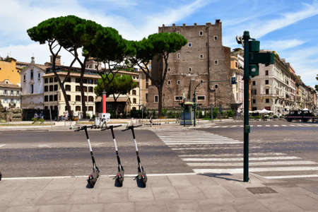 Rome, Italy - 07 26 2020: Central street of Rome full of scooters for rent left on the sidewalks.