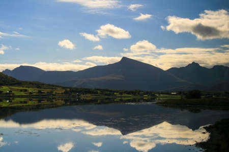 Wonderful panorama of Norwegian mountains and rocks that are reflected in the water.