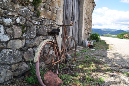 An old and rusty bike at a farm in France.の写真素材