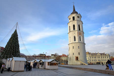 VILNIUS, LITHUANIA - DECEMBER 28, 2016: The Belfry (Cathedral Clock Tower) on Cathedral Square with Christmas tree and Christmas market stalls on the left hand sideのeditorial素材